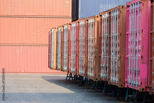 Fotografi container wall Multi-colored containers isolated on white Container warehouses l