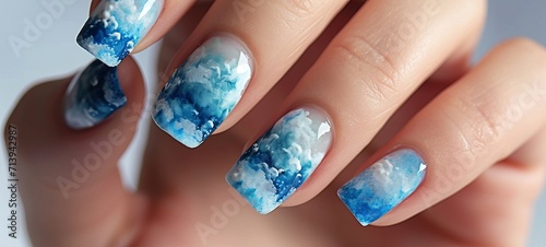 Nail art design summer sky, cloud, close up. Woman's fingernails with glossy nail polish. Manicure nail design photo