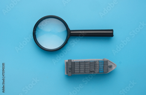 A picture of vessel miniature and magnifying glass. Search booking shipment photo