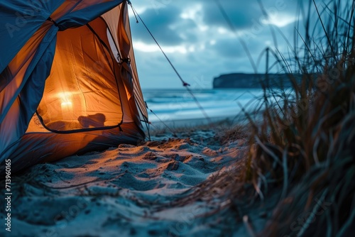 Sunset Serenity: Experience the Tranquility of Coastal Camping with a Tent Posing Silhouetted Against the Sandy Beach, Illuminated by the Soft Golden Hues of the Setting Sun.