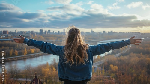 Behind a girl standing in front of a European city