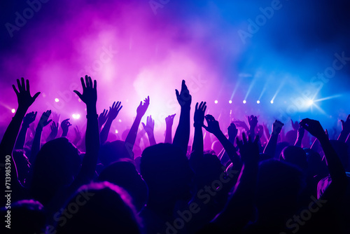 Energetic Crowd at a live concert with hands raised and colorful vibrant stage lights, music festival excitement concept