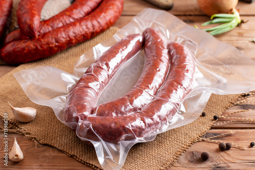 Smoked sausages in vacuum packaging on table