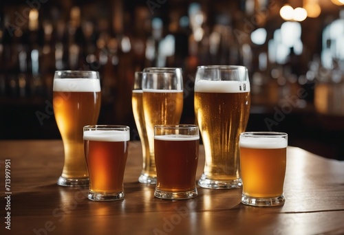 Glasses with craft beer on wooden bar Tap beer in pint glasses arranged in a row Closeup of five gla