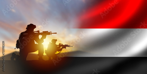 Soldiers with Yemen flag. Silhouettes of fighters at sunset. Yemen army. Military anti-terrorist operation concept. Soldiers state army. Yemen armed forces. Defense and anti-invasion forces. 3d image photo