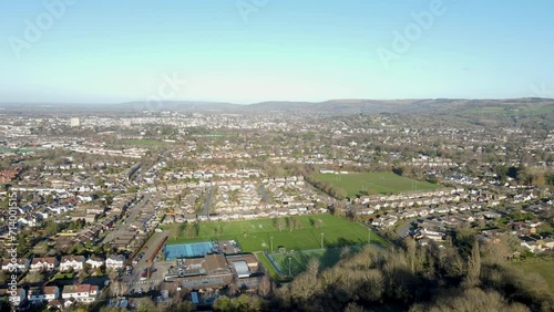 Aerial drone video flying towards Cheltenham, England, UK, from Leckhampton Hill looking north. View over the town. photo