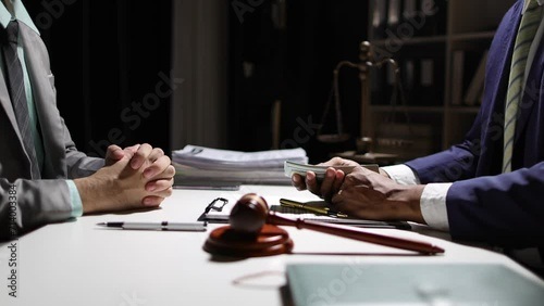 Corrupt lawyer accepts bribes from an unknown man in the dark. Businessman in the dark tries to bribe officials. photo