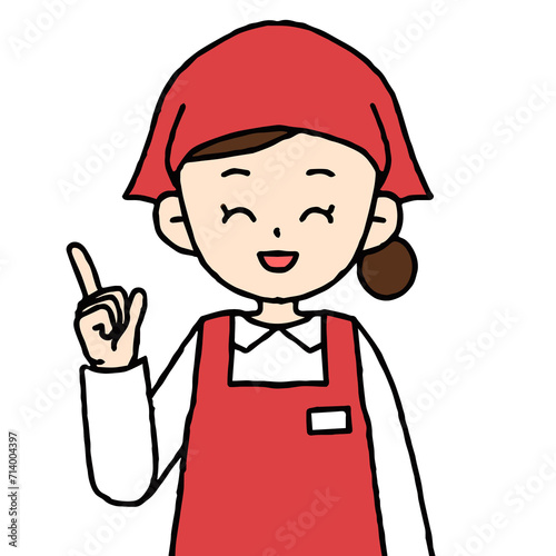エプロンを着けた女性店員が指差しをしている
