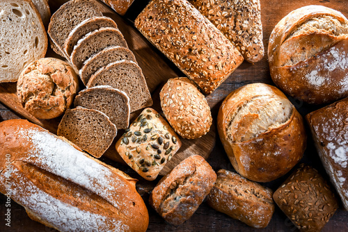 Assorted bakery products including loaves of bread and rolls photo