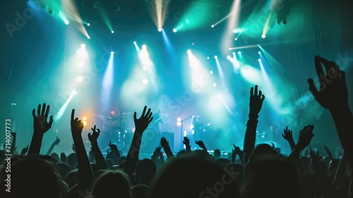 Concert Crowd with Raised Hands Under Stage Lights