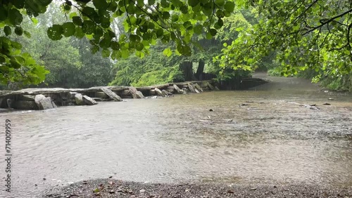 Torrential rain on the River Berle, at Tarr Steps, near Dulverton, Devon, England photo