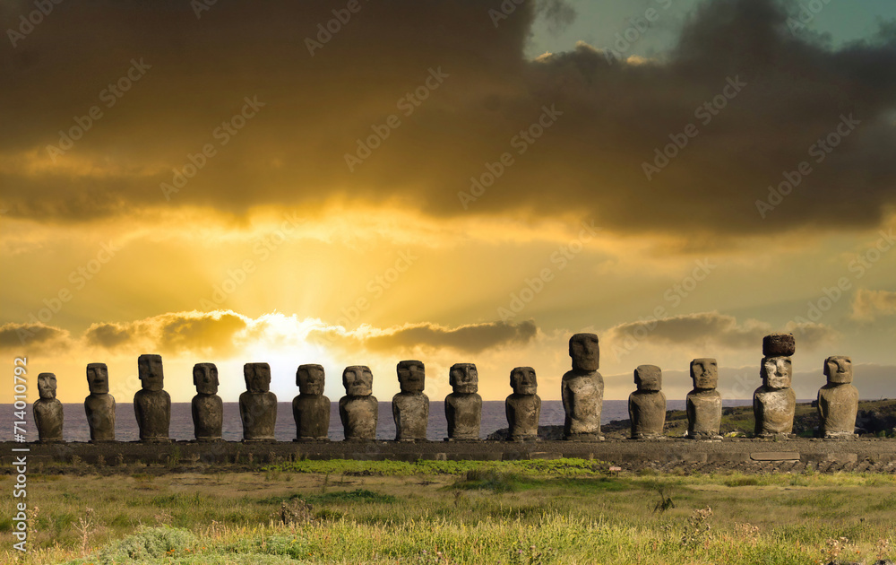 An evocative group of Moai statues illuminated by the light of dawn on the mysterious Easter Island (Rapa Nui), Chile