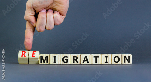 Migration or remigration symbol. Concept word Migration Remigration on beautiful wooden cubes. Beautiful grey background. Businessman hand. Business migration or remigration concept. Copy space. photo