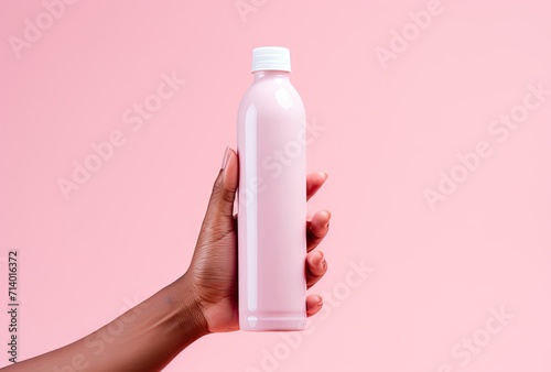 Drinking water presented in a bottle with a refreshing pink hue. photo