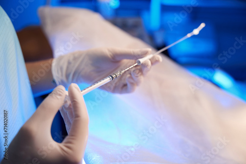 Close up of doctor hands using syringe for artificial fertilization