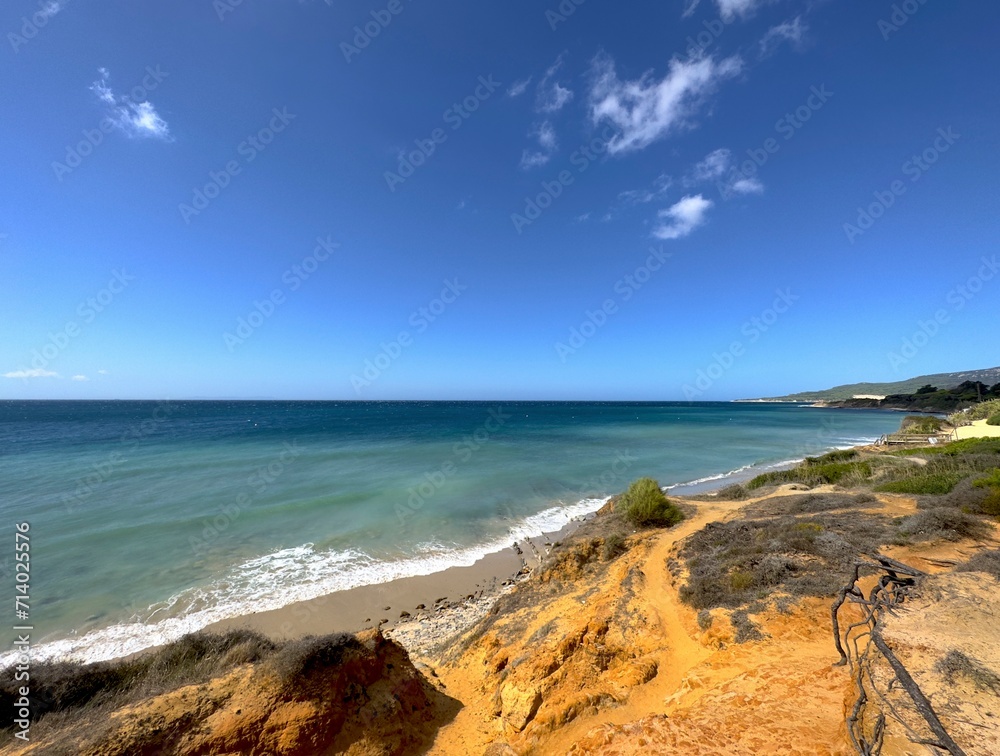 orange colored coast between Tarifa and Valdevaqueros with a view towards the Atlantic Ocean, Costa de la Luz, Andalusia, Spain