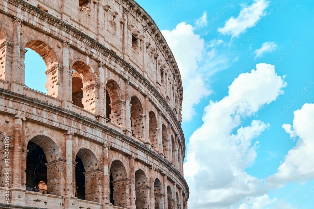 The Colosseum, Architectural wonder of Roman Empire (Colosseo) with blue sky background and clouds, Rome, Italy