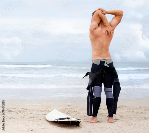 Photography Back of surfer, man is stretching and beach, surfboard for ocean waves and start fitness, adventure and travel