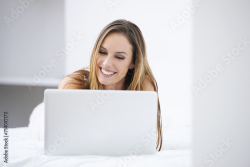 Happy woman, bedroom and laptop for planning, search on website and registration or streaming at home. Young person relax on bed with computer for morning news, social media update or reading blog