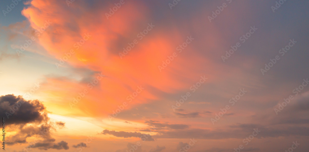 Sunset sky. Abstract nature background. Dramatic blue with orange colorful clouds in twilight time.