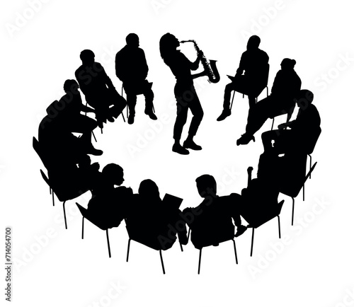 Male musician playing saxophone in the middle of group people sitting in circle silhouettes.