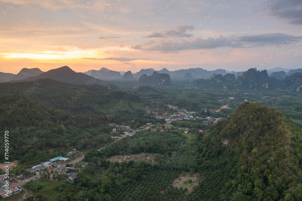 Aerial top view of Samet Nangshe, Phang Nga with city town, lush green trees from above in tropical forest in national park in summer season. Natural landscape. Pattern texture background.