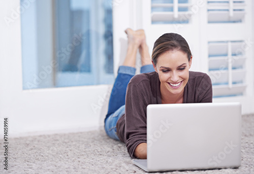 Woman, remote work and laptop to relax on floor, update blog post and digital news on social media at home. Happy freelancer, computer or download subscription, online shopping or streaming on ground