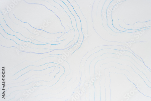 faint squiggly blue lines nearly in parallel on blank tracing paper