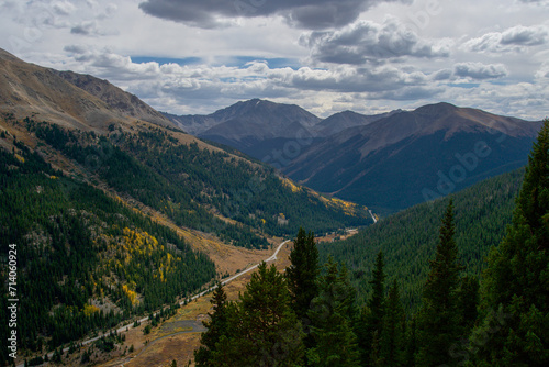 Colorado mountain landscape with a road winding through a pine forested valley © Roy Wilhelm
