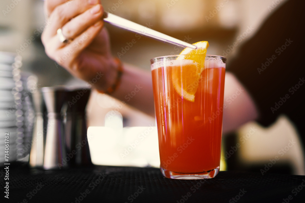 Bartender making alcohol cocktail in a bar, close-Up. Bartender making alcohol cocktail in a bar, close-Up.