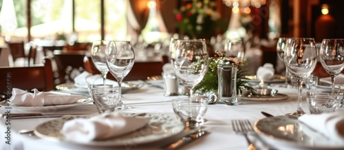 White attended a wedding celebration at a restaurant, setting a white tablecloth with silver utensils, plates, and glasses.
