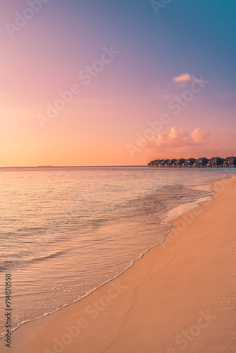 Sunset Maldives island tourism, luxury water villas wooden pier path resort. Beautiful sky ocean bay beach background. Summer vacation travel destination. Paradise sunrise landscape panoramic coast