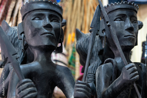 Banaue, Ifugao, Philippines - Jan 15, 2024: Traditional Ifugao wood figurines for sale at a local shop. photo