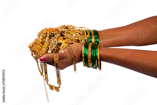 gold jewelery in hand isolated on white background.