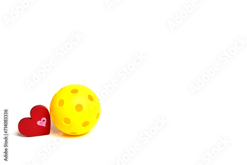 Pickleball Love...Yellow Pickleball with red heart on a white background.