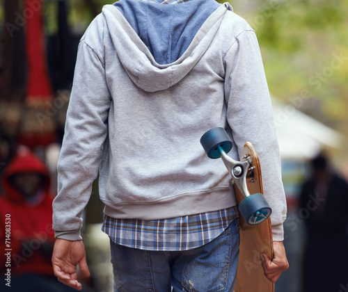 Back, closeup and man with a skateboard, outdoor and fitness with exercise, hipster and freedom. Extreme sports, person and cool guy with balance, New York city and skater with summer break or travel