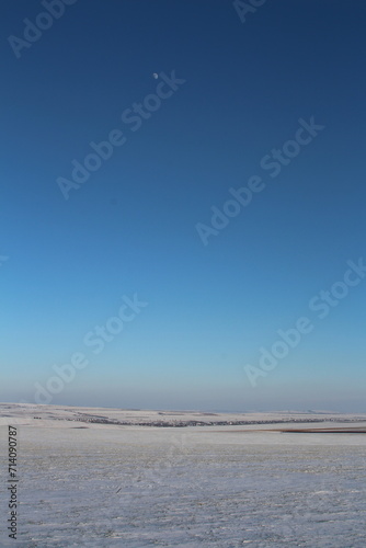 A snowy landscape with a blue sky