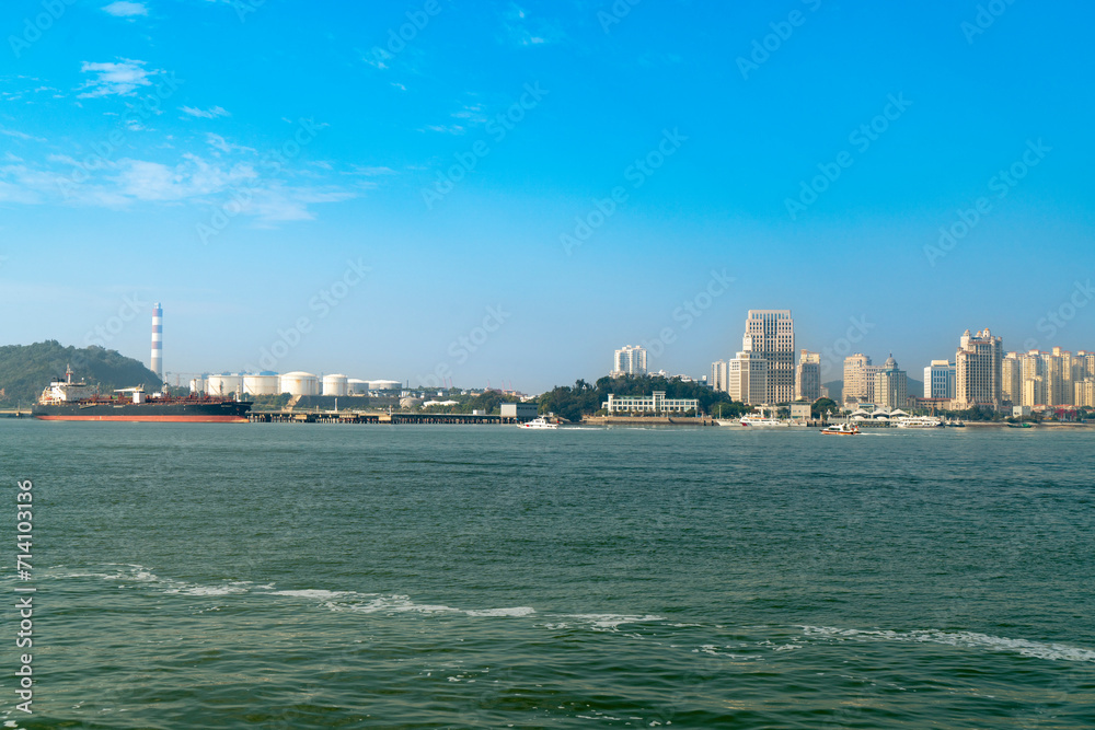Ships docked at the port and city skyline, Xiamen, China