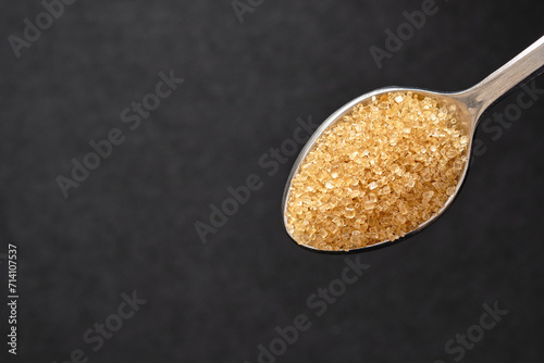 Top view, Teaspoon of brown sugar, Close up of cane sugar copy space for text.