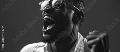 In a monochrome world, a man's exuberant laughter is a burst of light, his joy an undeniable force photo