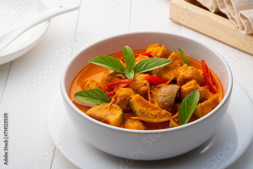 Red curry with clown featherback fishball in white bowl (Gaeng Kua Look Chin pla) photo