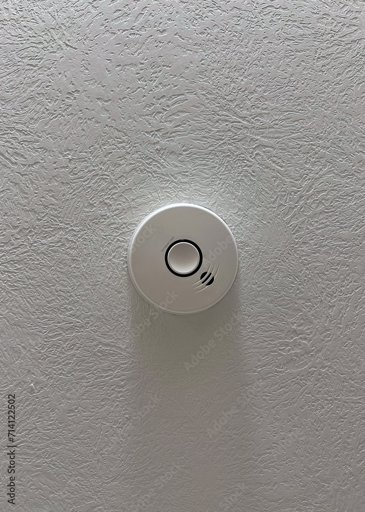 Fire and carbon monoxide detector installed on a textured ceiling Fire and carbon monoxide detector installed on a textured ceiling