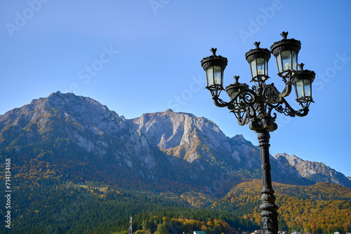 Sunset mountain range with a decorative iron lamp post near the town of Busteni, Transylvania, Romania