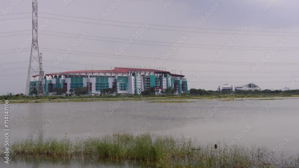 view of fish ponds with stadium buildings in Surabaya view of fish ponds with stadium buildings in Surabaya