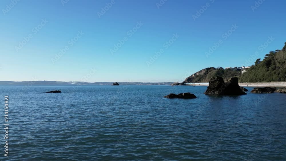 Meadfoot beach, Torbay, South Devon, England: DRONE VIEWS: A low angle view of Swans, offshore rocks and Meadfoot beach, which is located close to the popular UK holiday resort of Torquay (Clip 1).