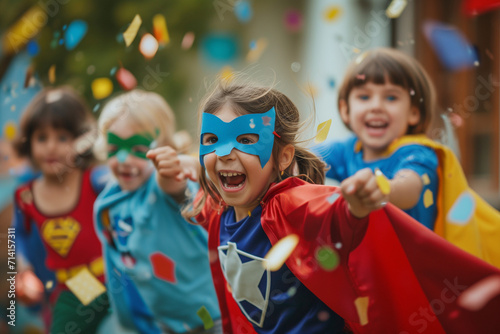 Cheerful children in superhero costumes at carnival photo