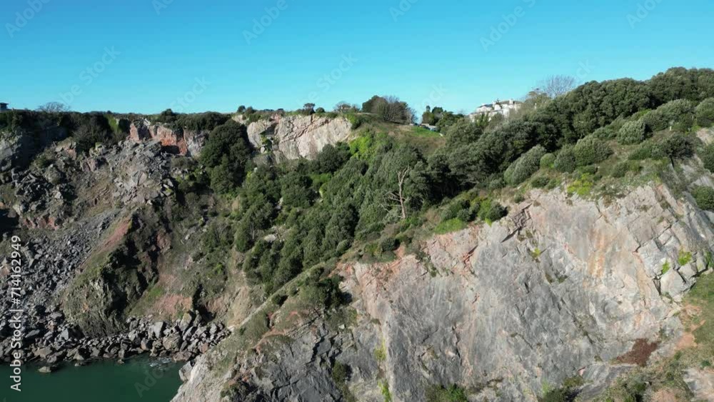 Meadfoot beach, Torbay, South Devon, England: DRONE VIEWS: The drone ascends up a limestone and sandstone cliff face to Meadfoot beach, Torbay, South Devon, England: DRONE VIEWS: The drone ascends up a limestone and sandstone cliff face to