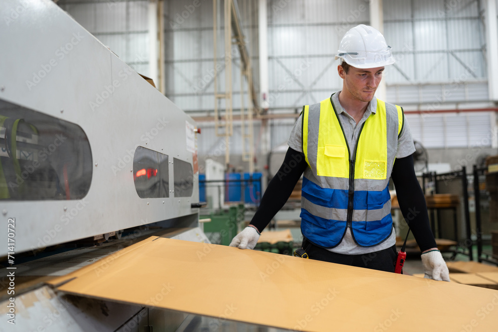 Caucasian businessman working and control machine at Kraft paper factory Caucasian businessman working and control machine at Kraft paper factory