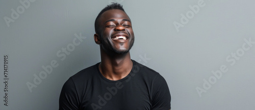 Joyful laughter radiates from a man enjoying a light-hearted moment