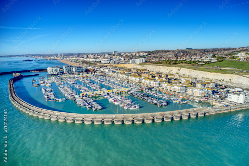 Brighton Marina in East Sussex, Southern England, with chalk cliffs and Brighton City in the background, Aerial photo from the sea. - obrazy, fototapety, plakaty 